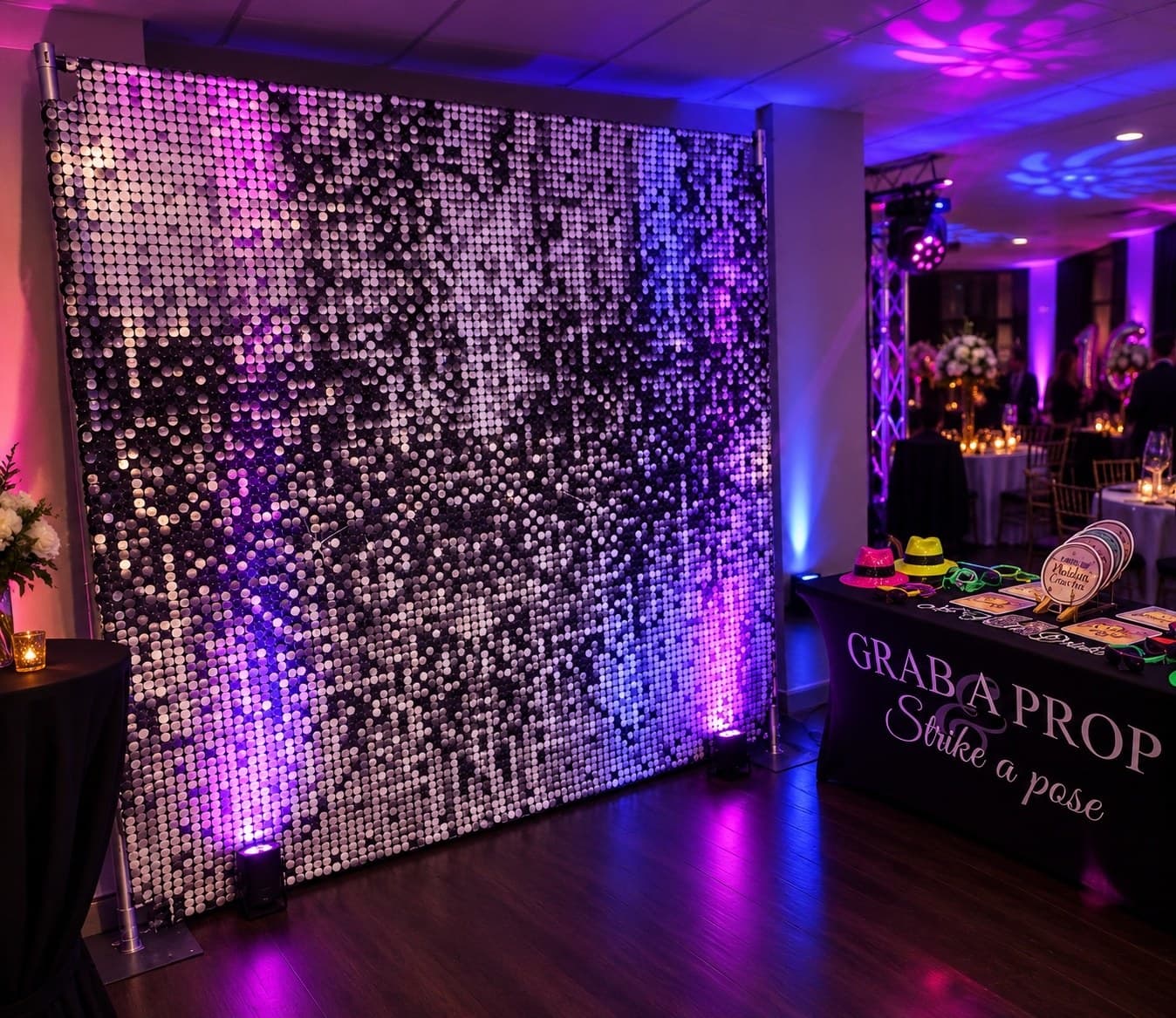 Professional photo booth setup with backdrop and props at a celebration