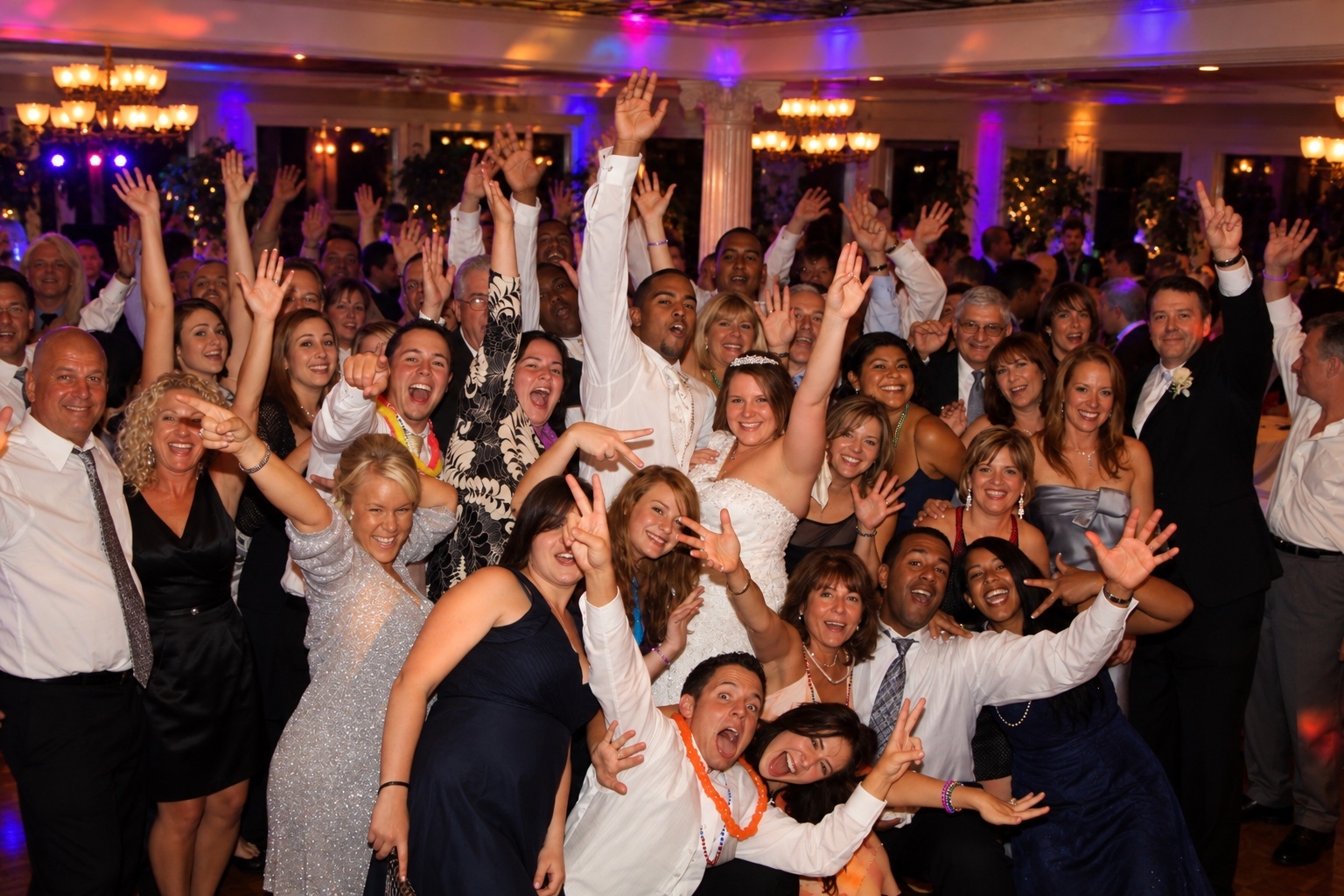 Large wedding group celebrating together